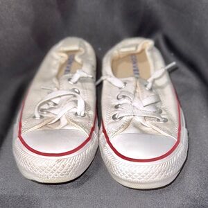 Converse Shoreline slip-on sneakers in white canvas with a red stripe detail.